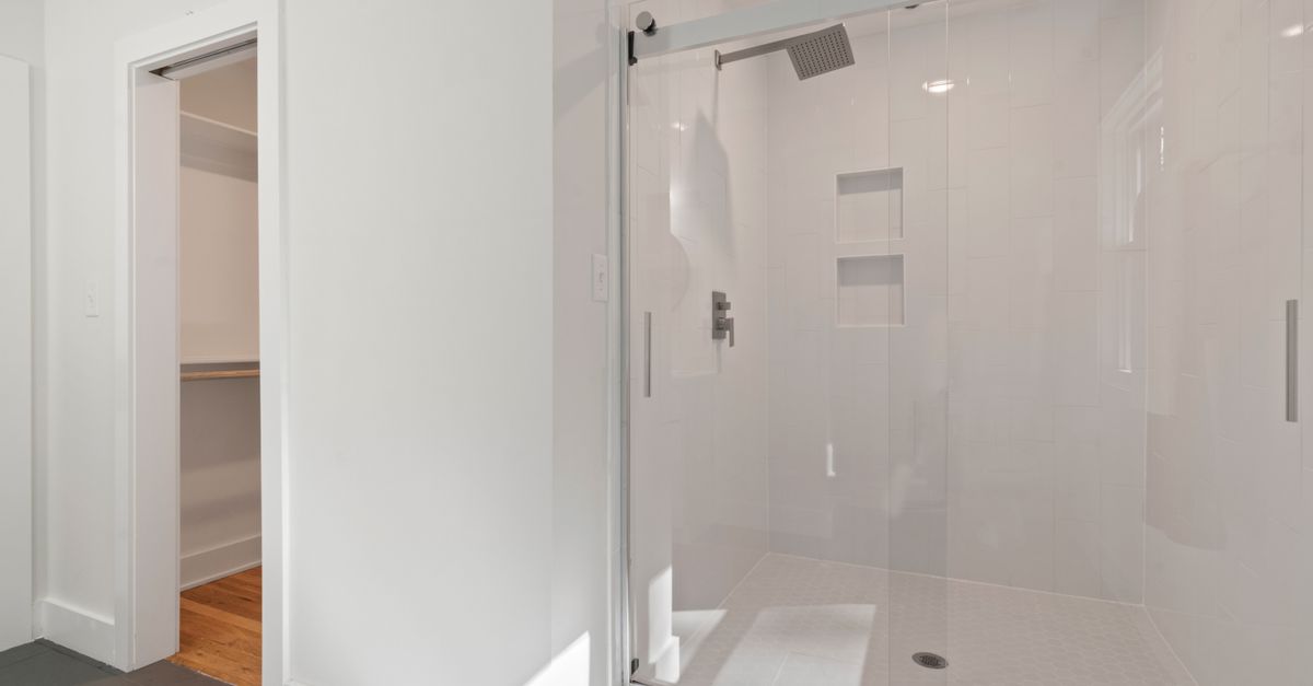 A bright, accessible shower enclosure with a clean, simple layout.