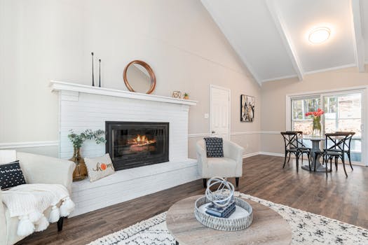 Stylish living room with a white brick fireplace, modern decor, and dining area in a bright, airy space.