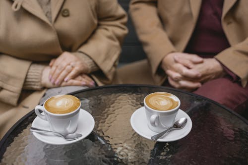 Free Cups of Coffee Latte over a Glass Table Stock Photo