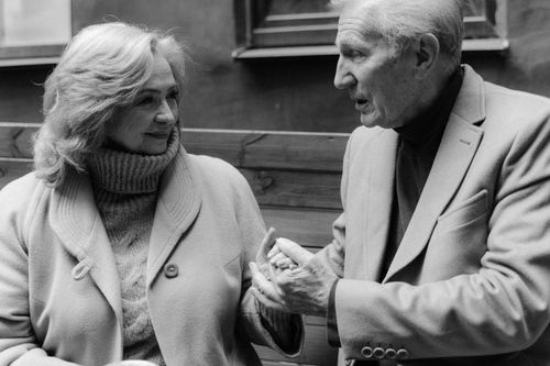 Free Black and white photo of an elderly couple sharing a moment, holding hands and connecting. Stock Photo