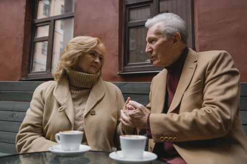 Free Senior couple sharing an intimate moment over coffee in a cozy setting, showcasing love and connection. Stock Photo