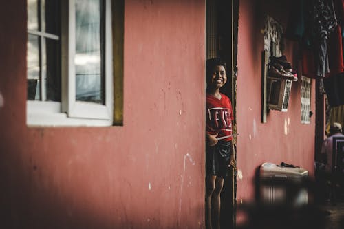 A Boy Standing in the Doorway