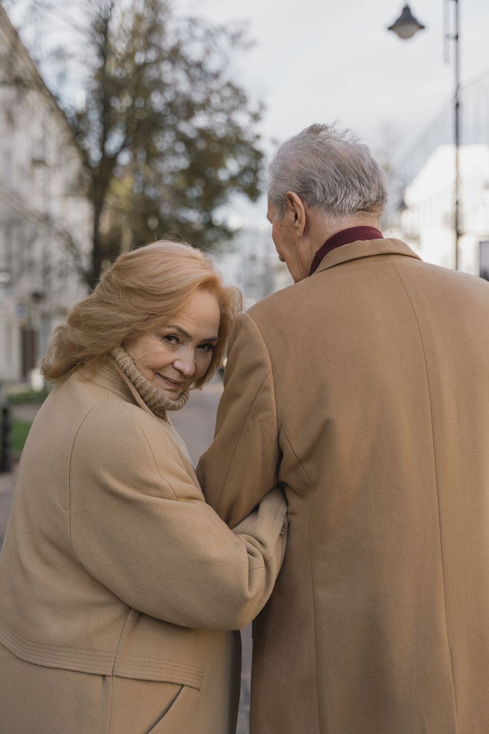 A couple in their sixties walking together outdoors