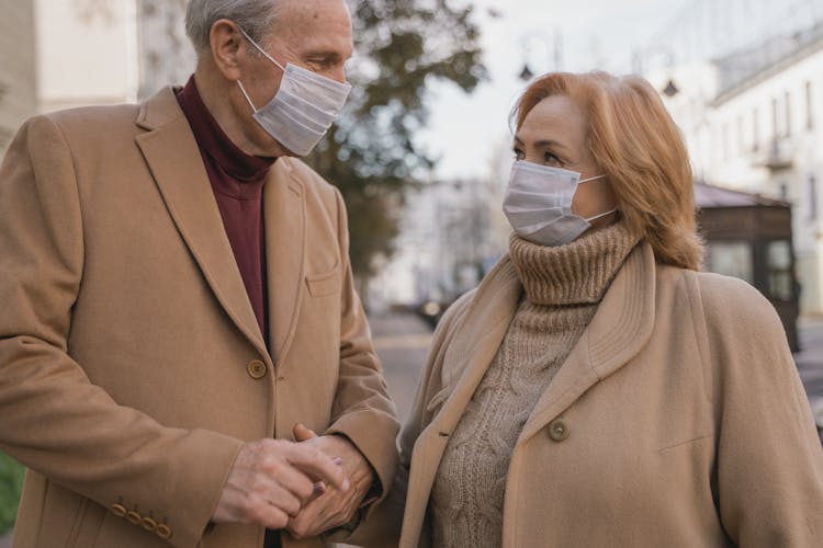 An Elderly Couple Wearing Facemasks Outdoor