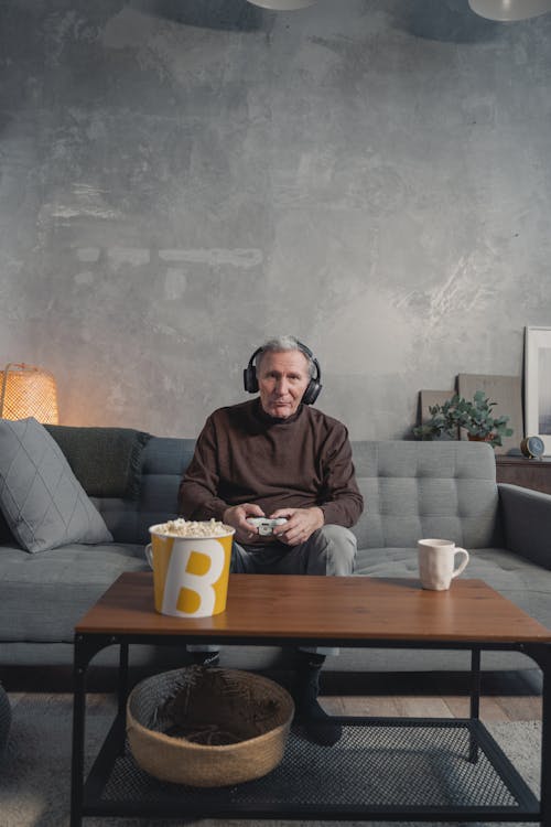 A Man Wearing a Headphone While Holding a Game Controller