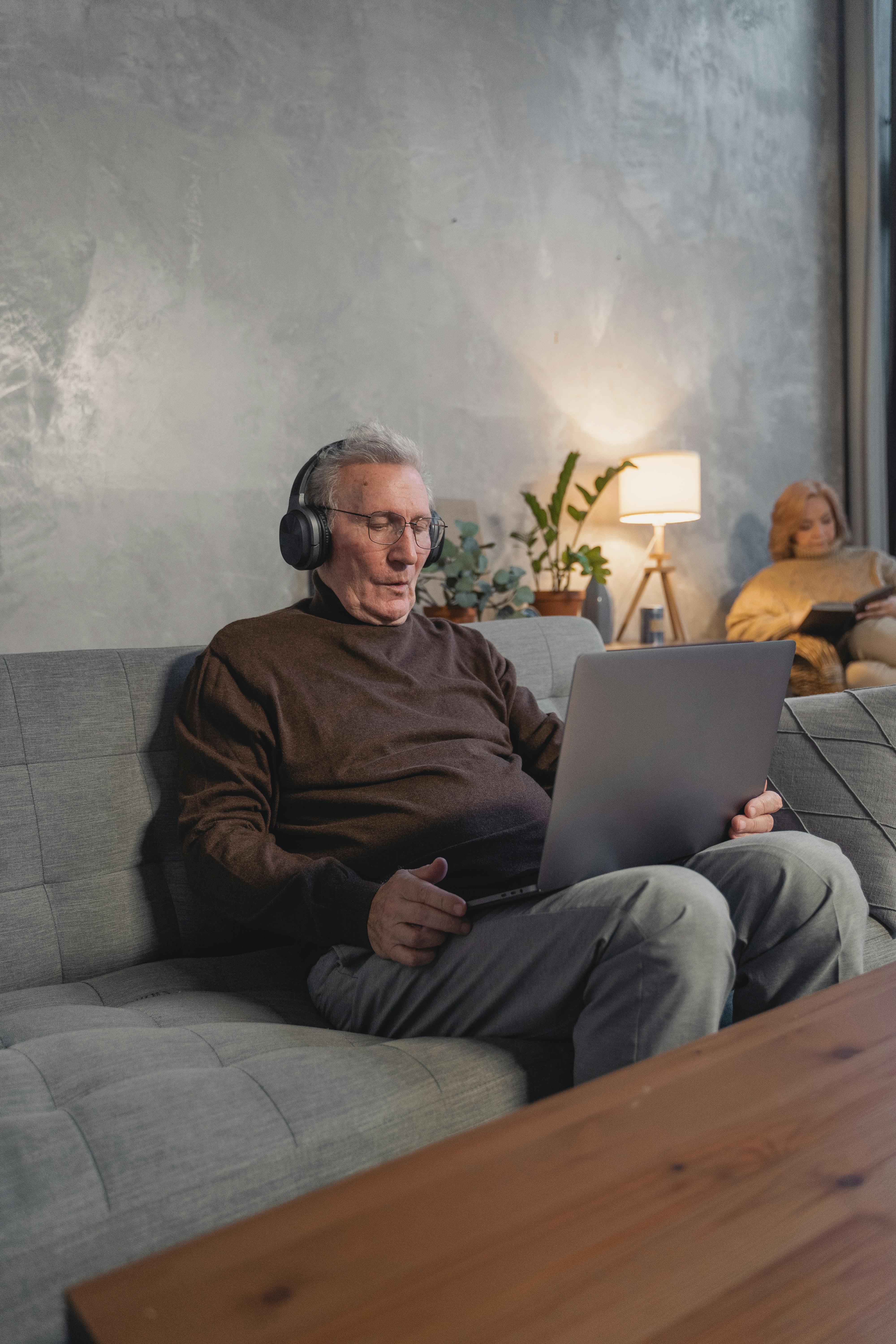 man using laptop and wearing headset