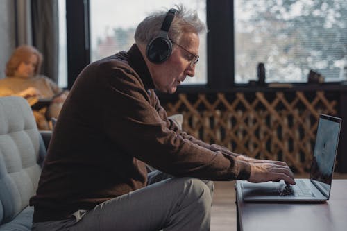 Side View of a Man Using a Laptop