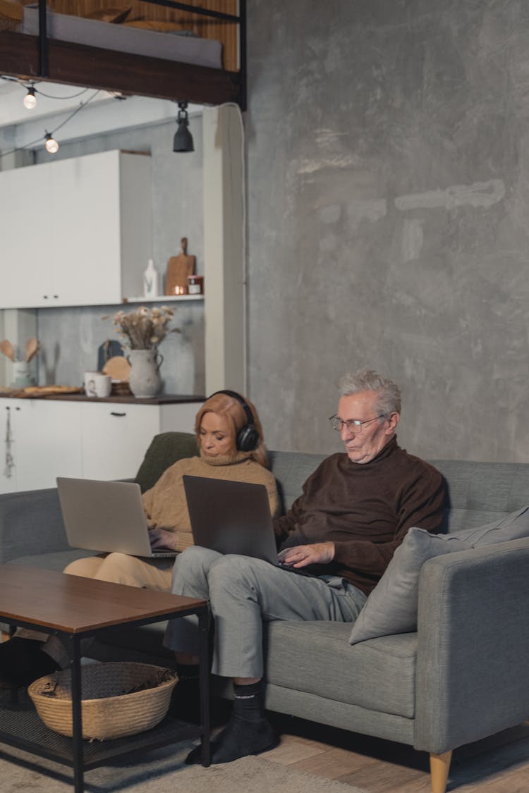 A Man And Woman Using Laptop