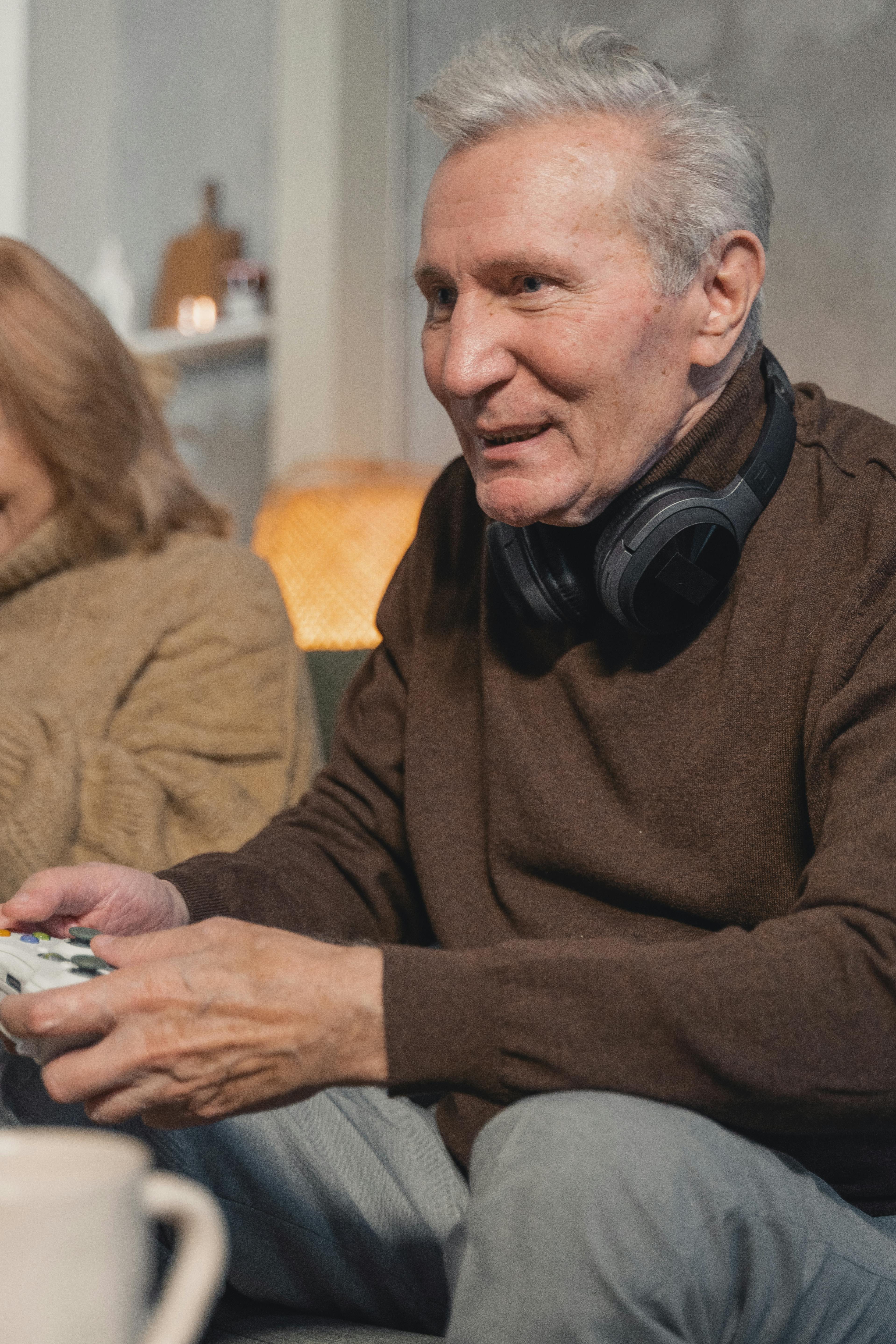 an elderly man playing a video game