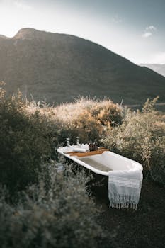 Serene outdoor scene with a vintage bathtub surrounded by lush greenery, perfect for nature lovers.