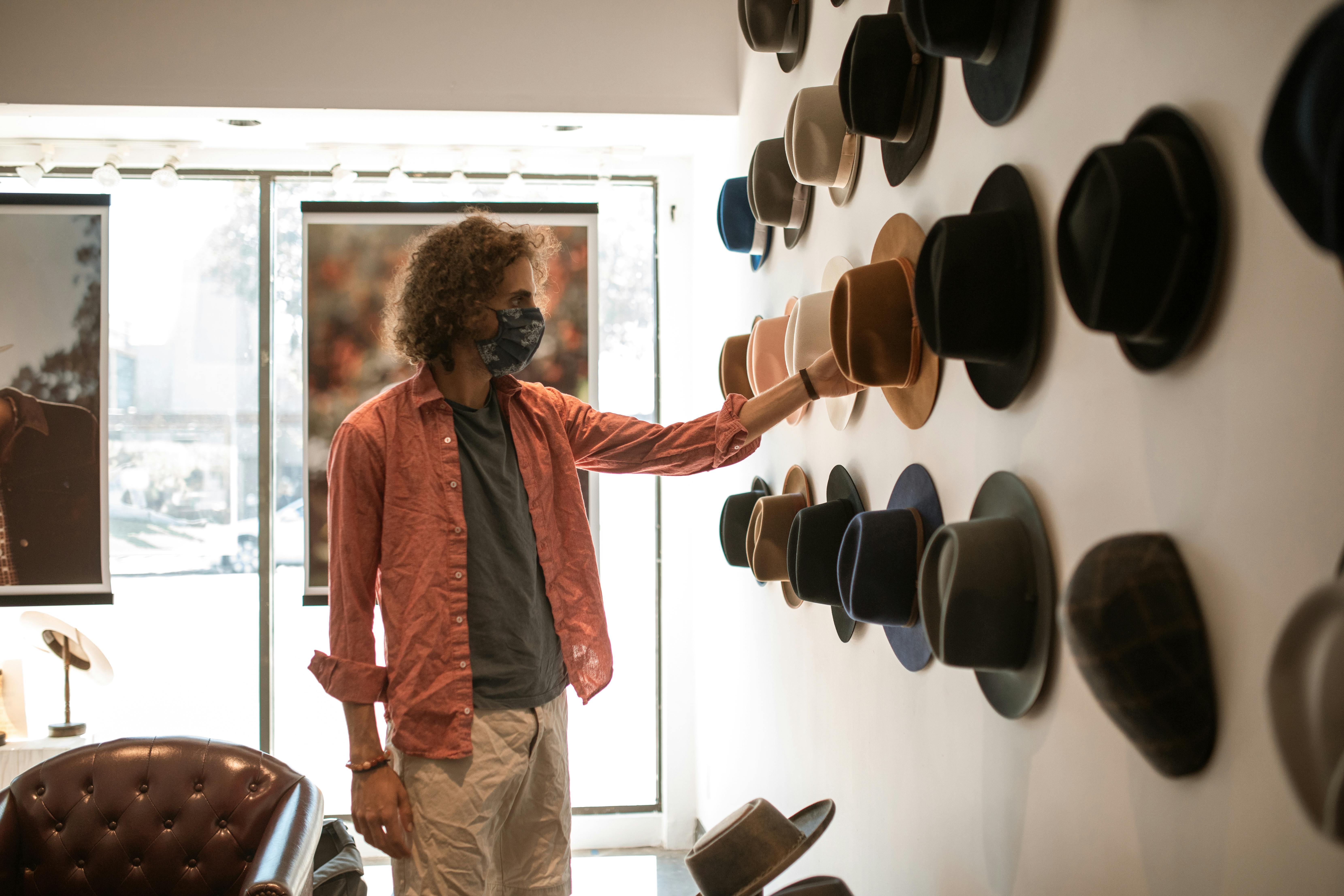 a shopper looking at hats