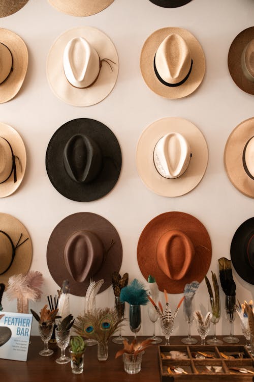 Free Brown and White Hat on White Textile Stock Photo