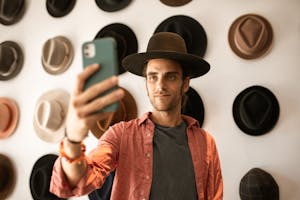 Stylish Man Taking a Selfie inside a Boutique