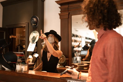 A fashionable woman assists a customer in a chic hat boutique, highlighting style and shopping experience.