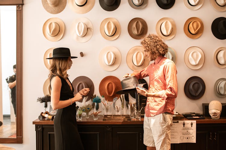 A Couple Shopping For Hats