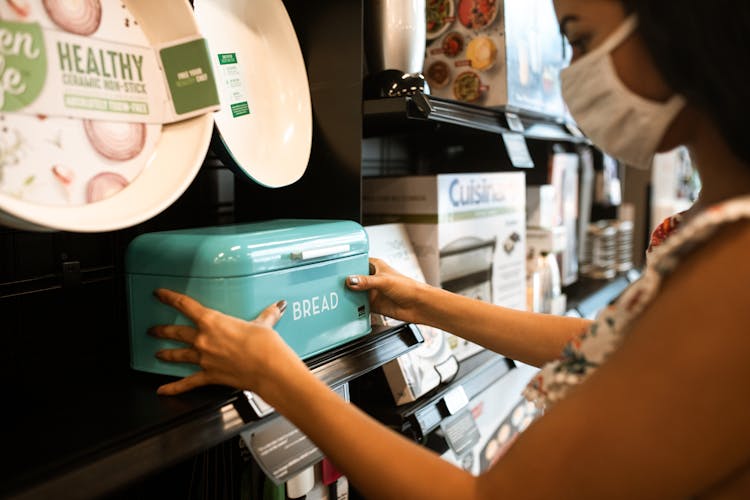 Person Holding A Green And White Steel Bread Bin 