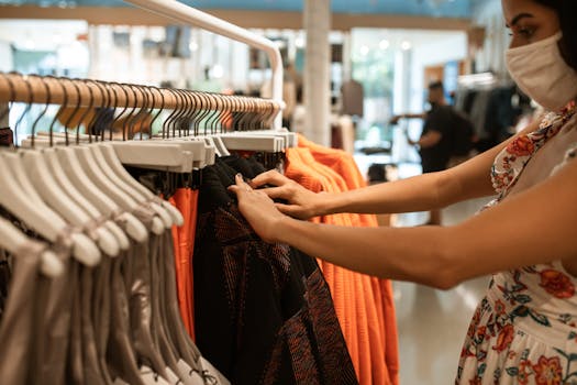 A woman shops for clothes in a store while wearing a face mask, highlighting the new normal.