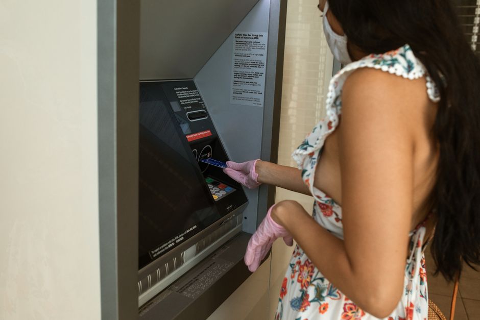 Tourist using an ATM located inside a secure bank branch in Jakarta, Indonesia
