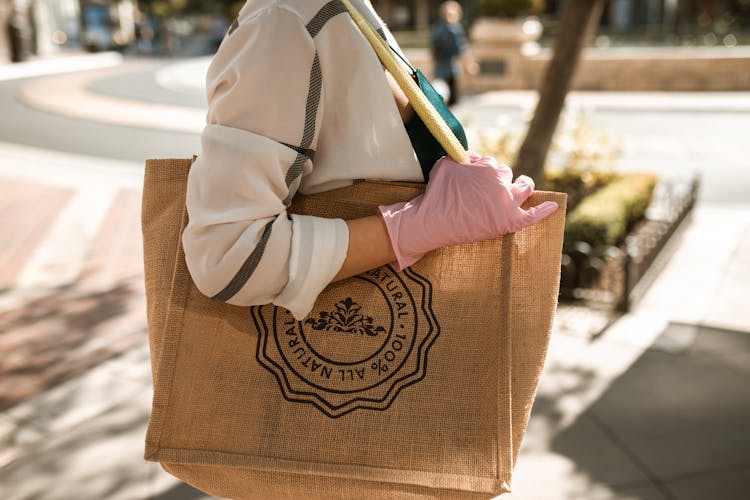 Close-Up Shot Of A Person Carrying A Brown Tote Bag