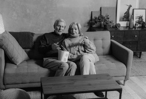 A Elderly Couple Sitting on a Couch