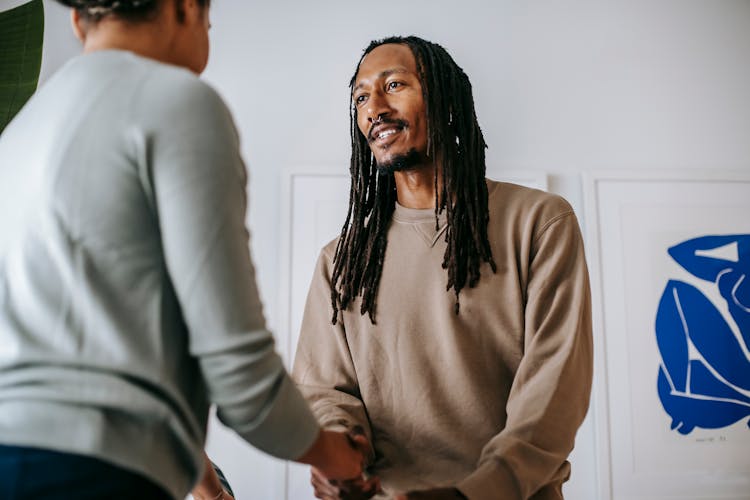 Black Man Greeting Crop Psychologist In Office