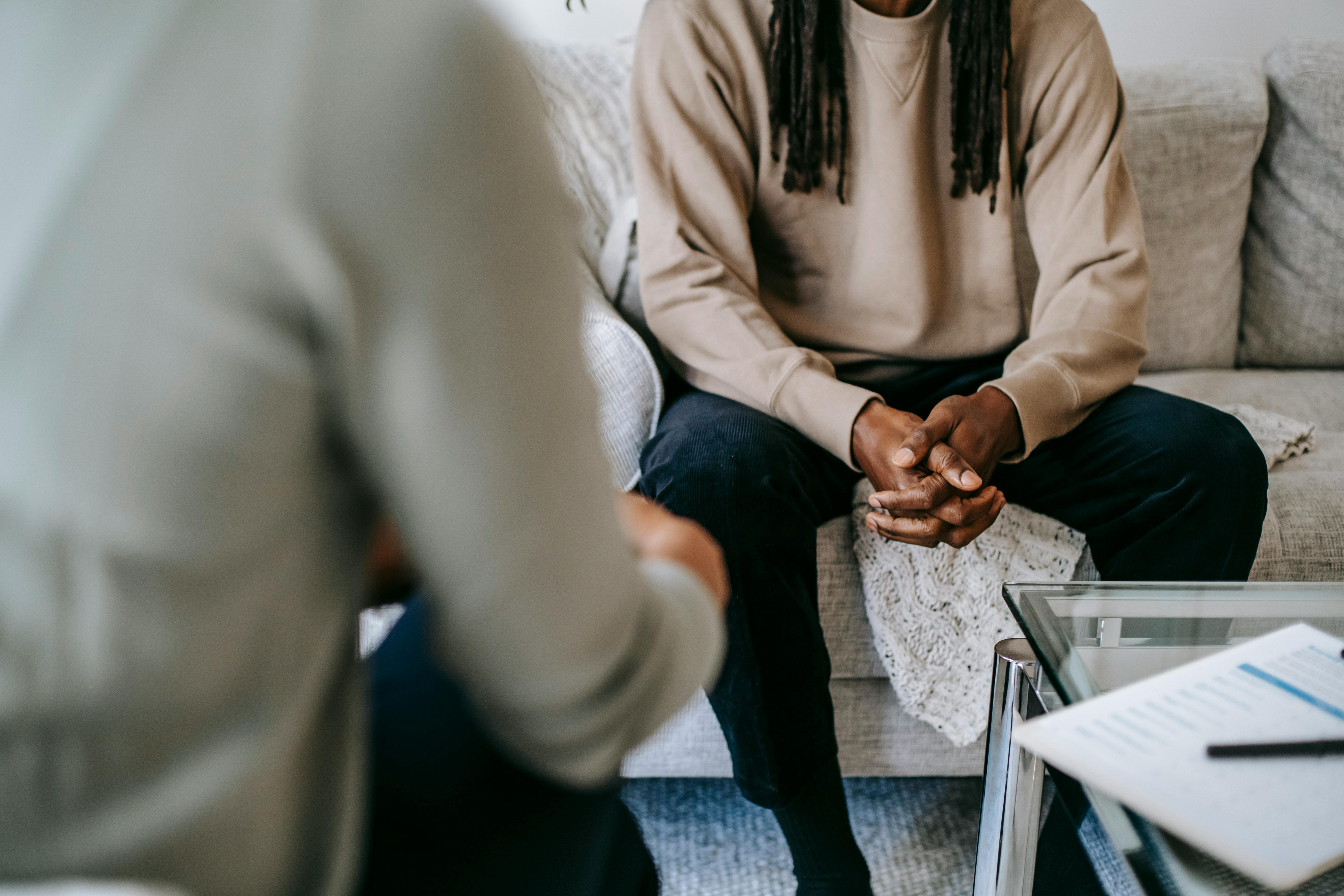 crop black man speaking with psychologist