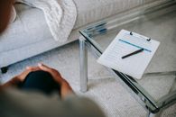 Crop woman in office with clipboard
