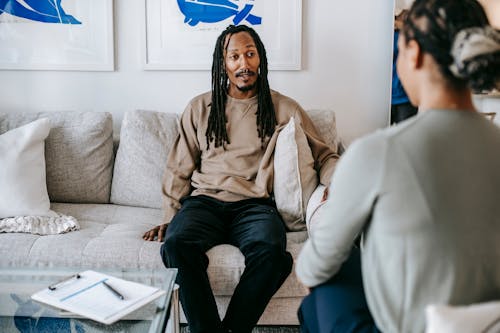 Free Black man having conversation with psychologist Stock Photo