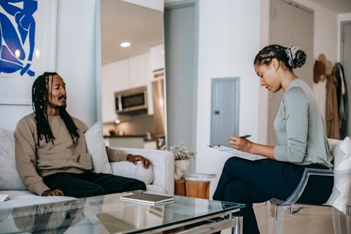 Black man speaking with psychologist