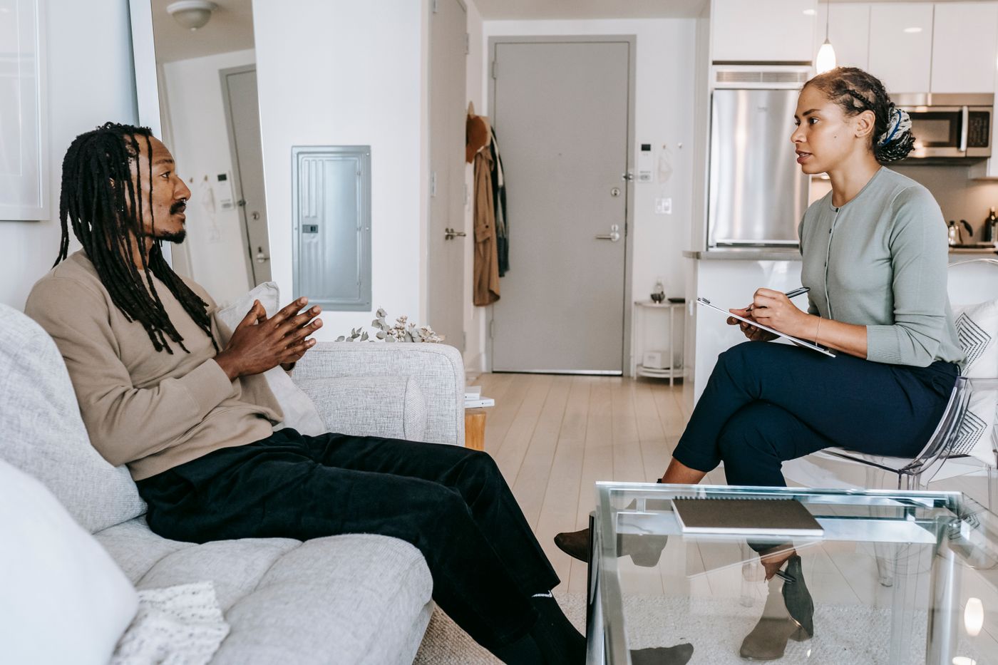 Therapist speaking with a client in a calm counseling setting