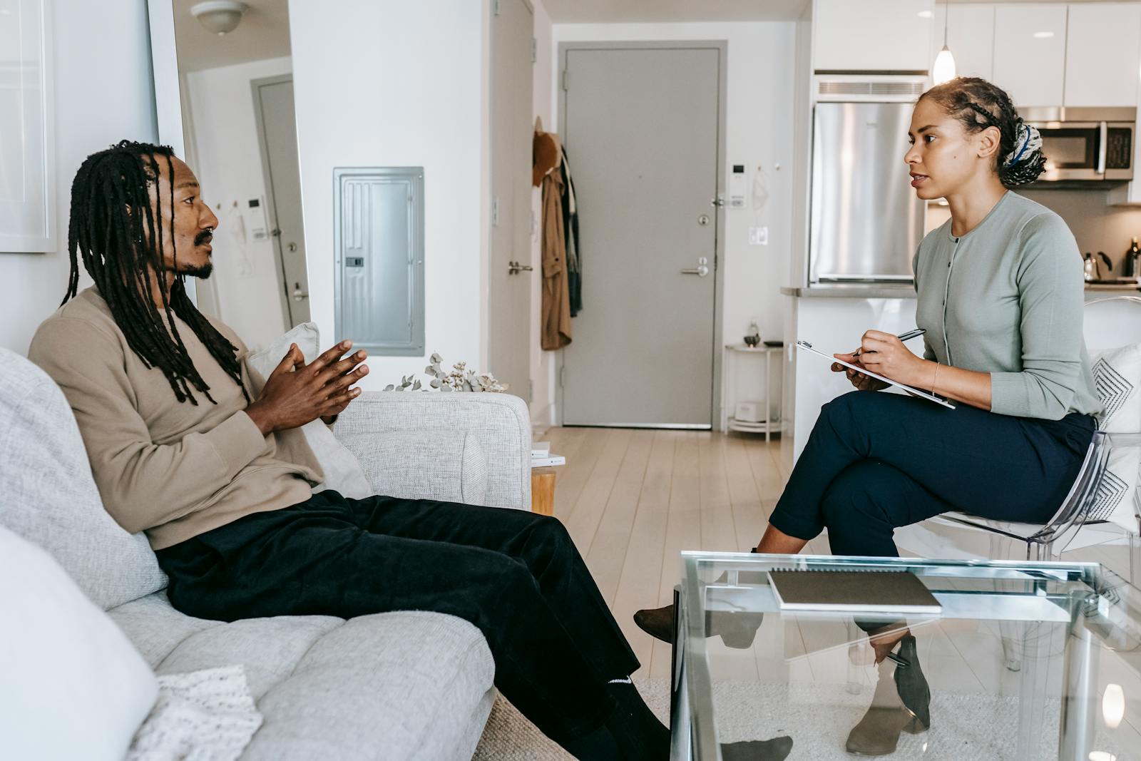 Two women sitting at a table having a serious but calm conversation