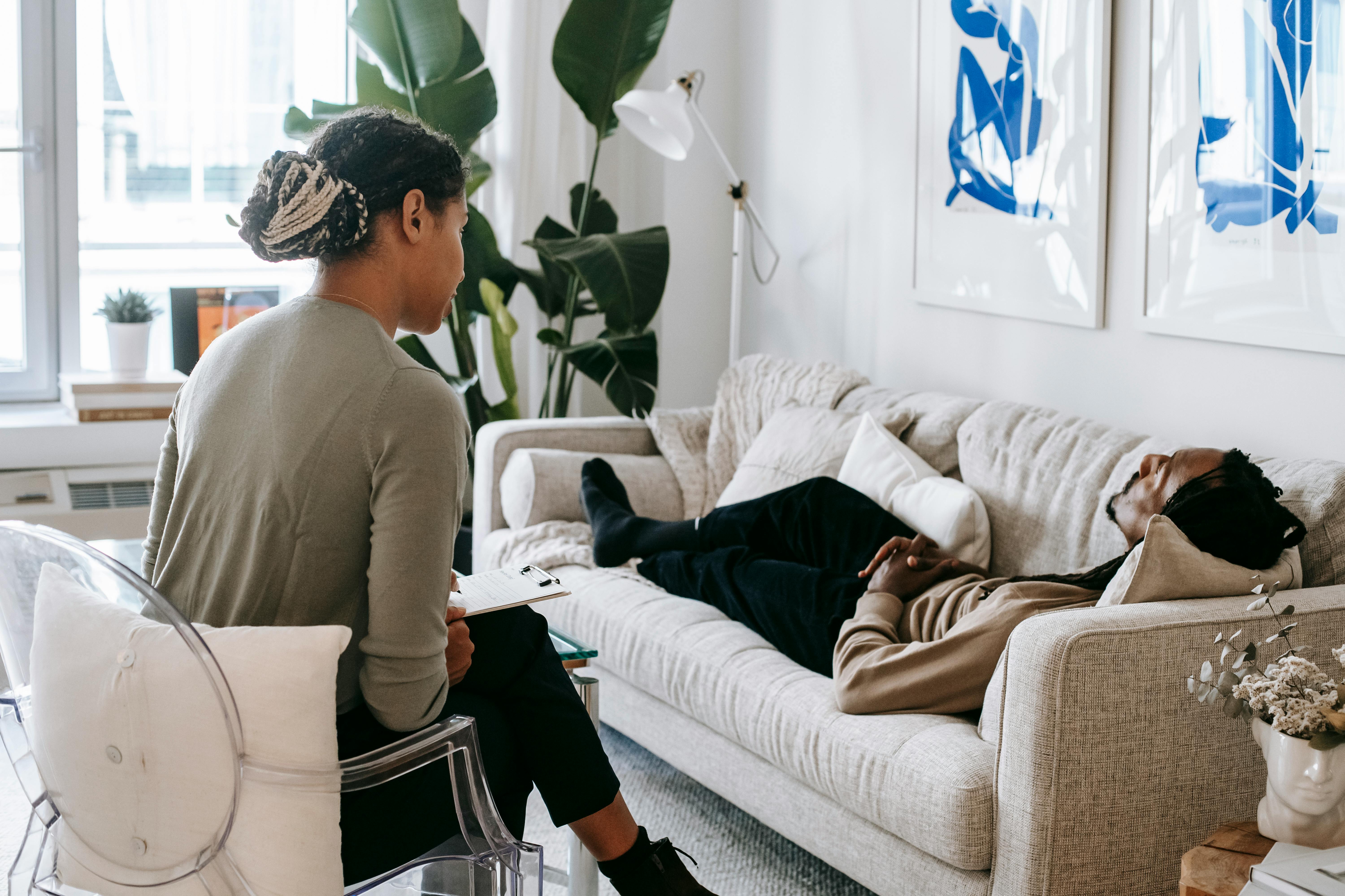 ethnic man lying near psychologist