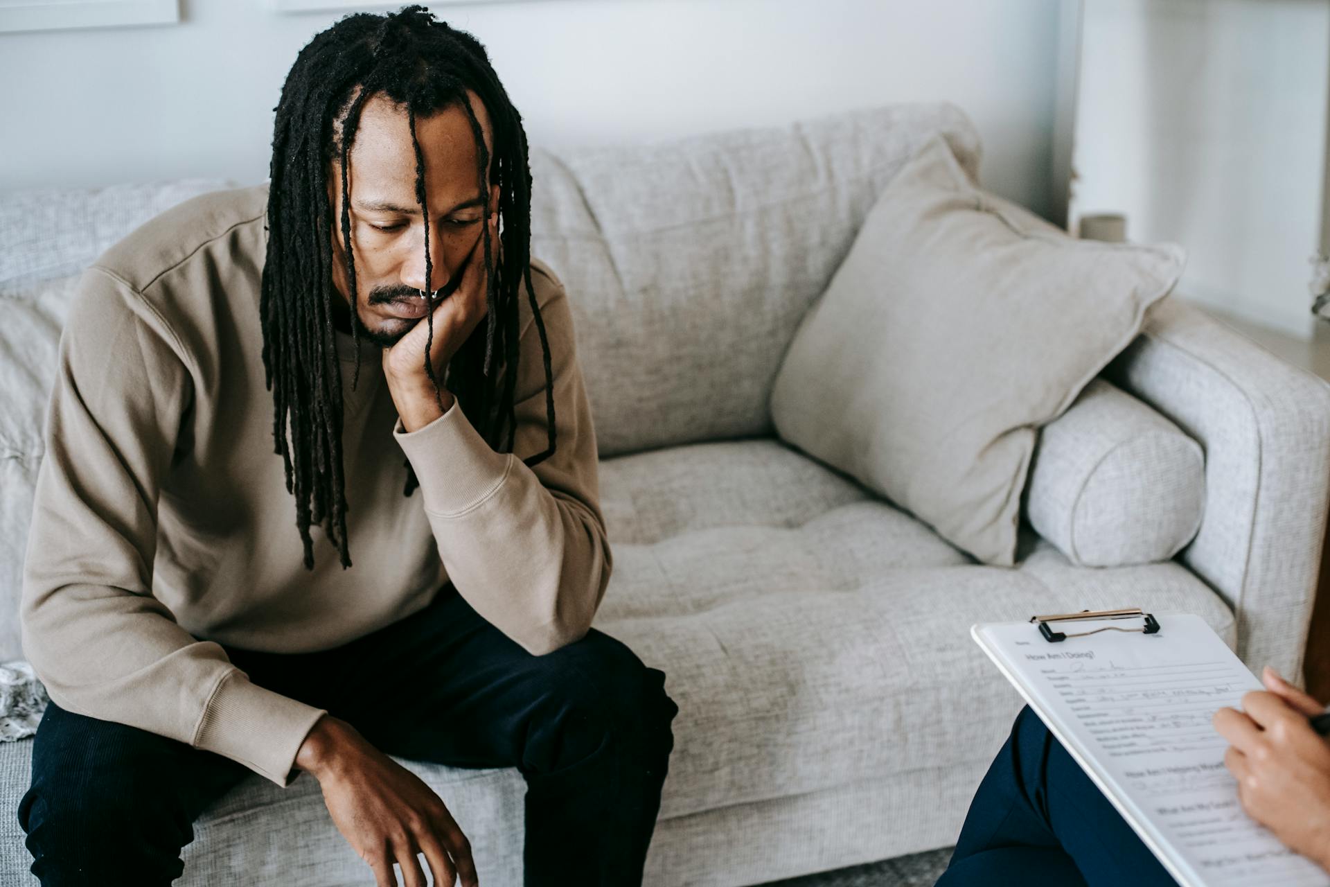 Melancholic black man in psychologist office