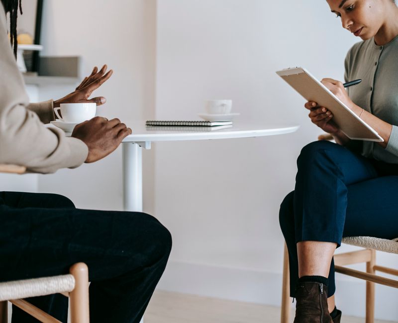 Adult engaged in ABA therapy session with therapist