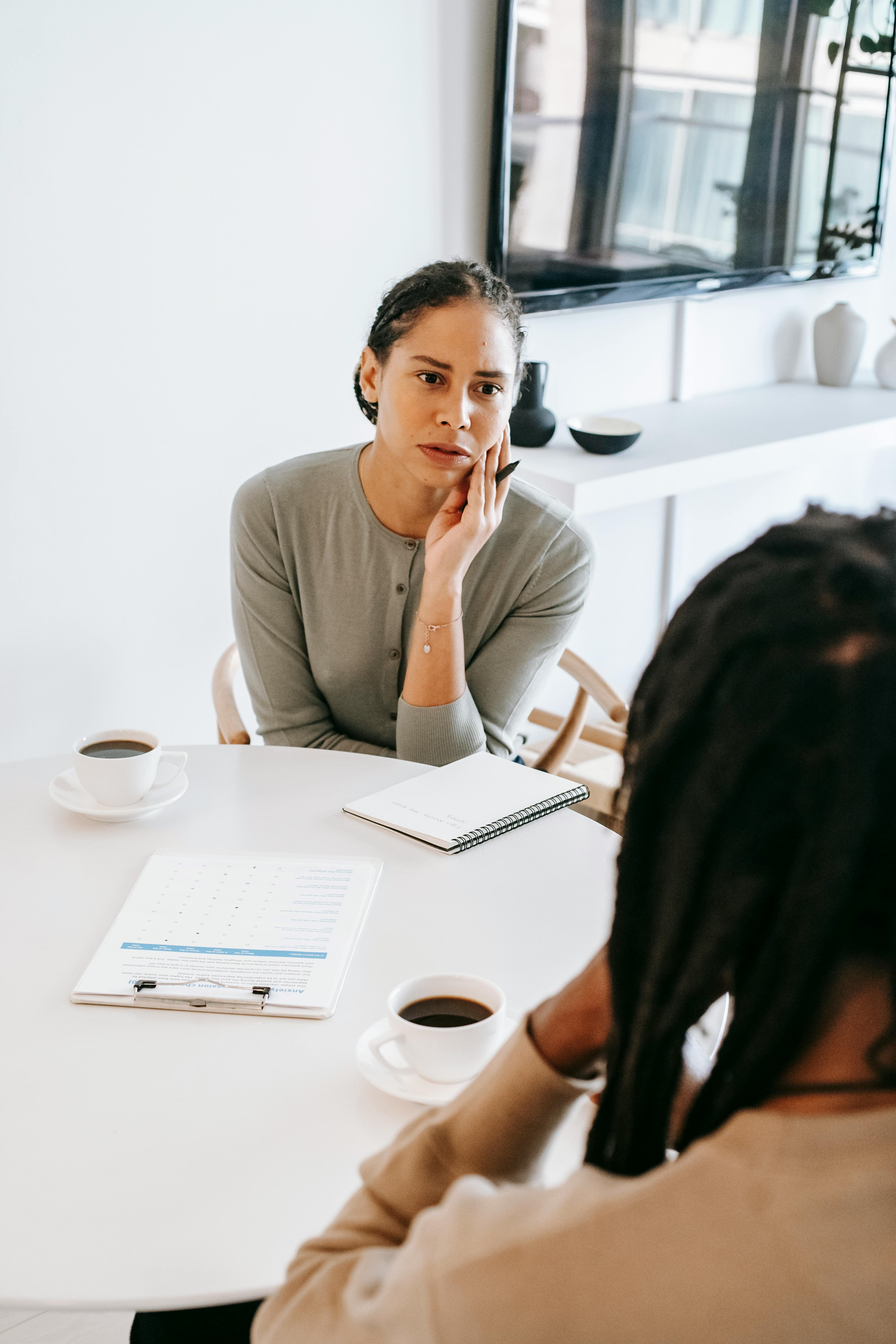 attentive female counselor listening to male patient