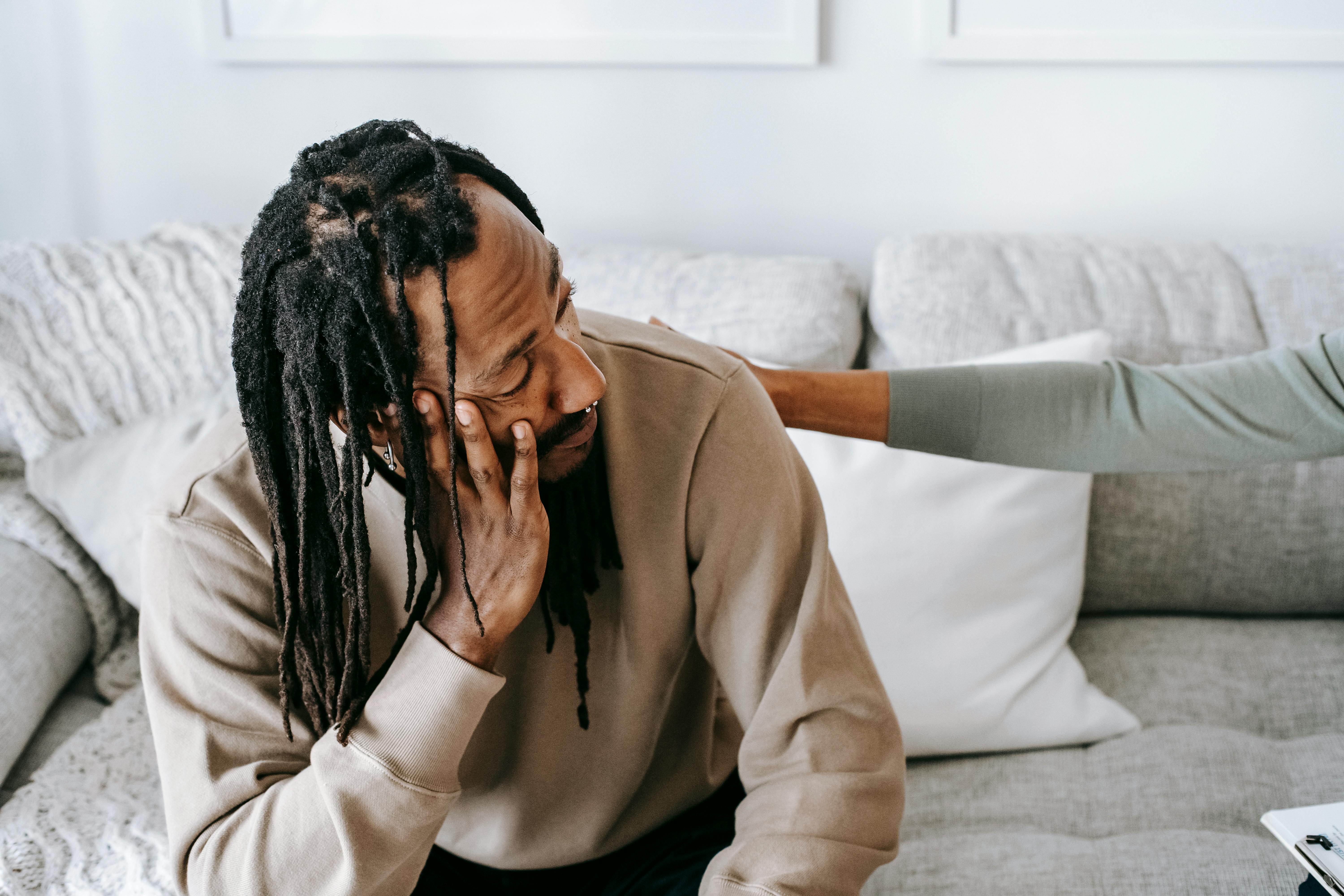 frustrated black man talking to female psychologist or friend