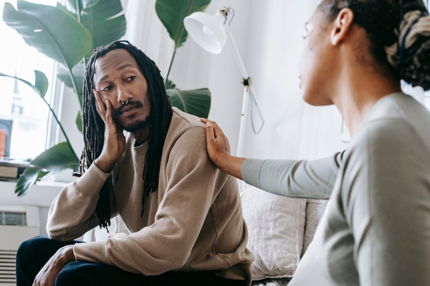 Two Black adults having a calm supportive conversation