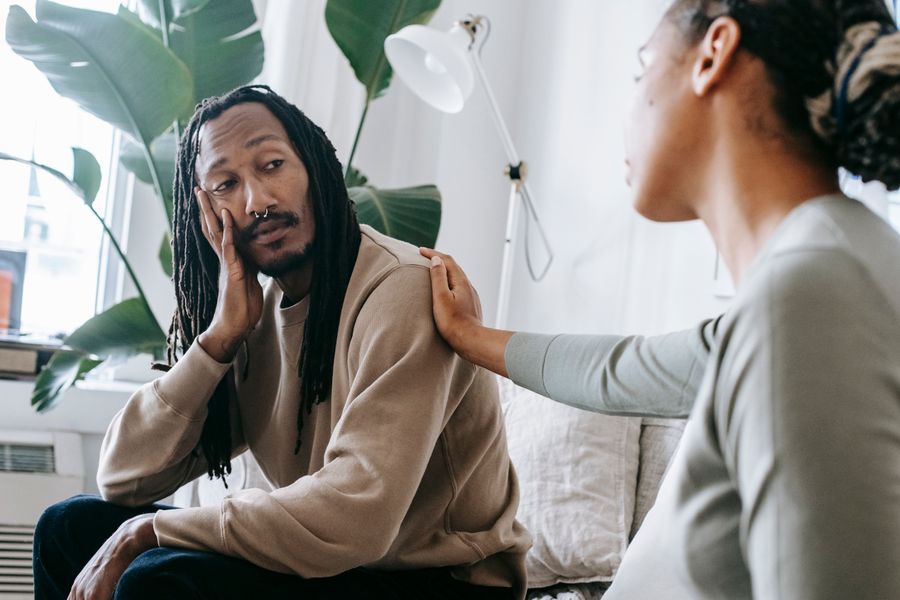 Black adults having a supportive one-to-one conversation