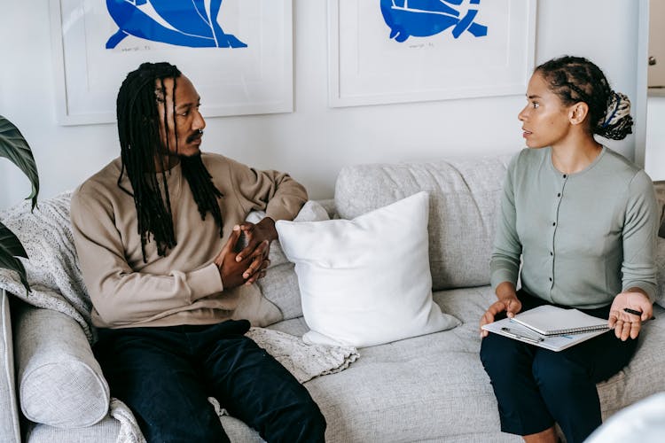 Black Man Listening To Female Psychologist Advice