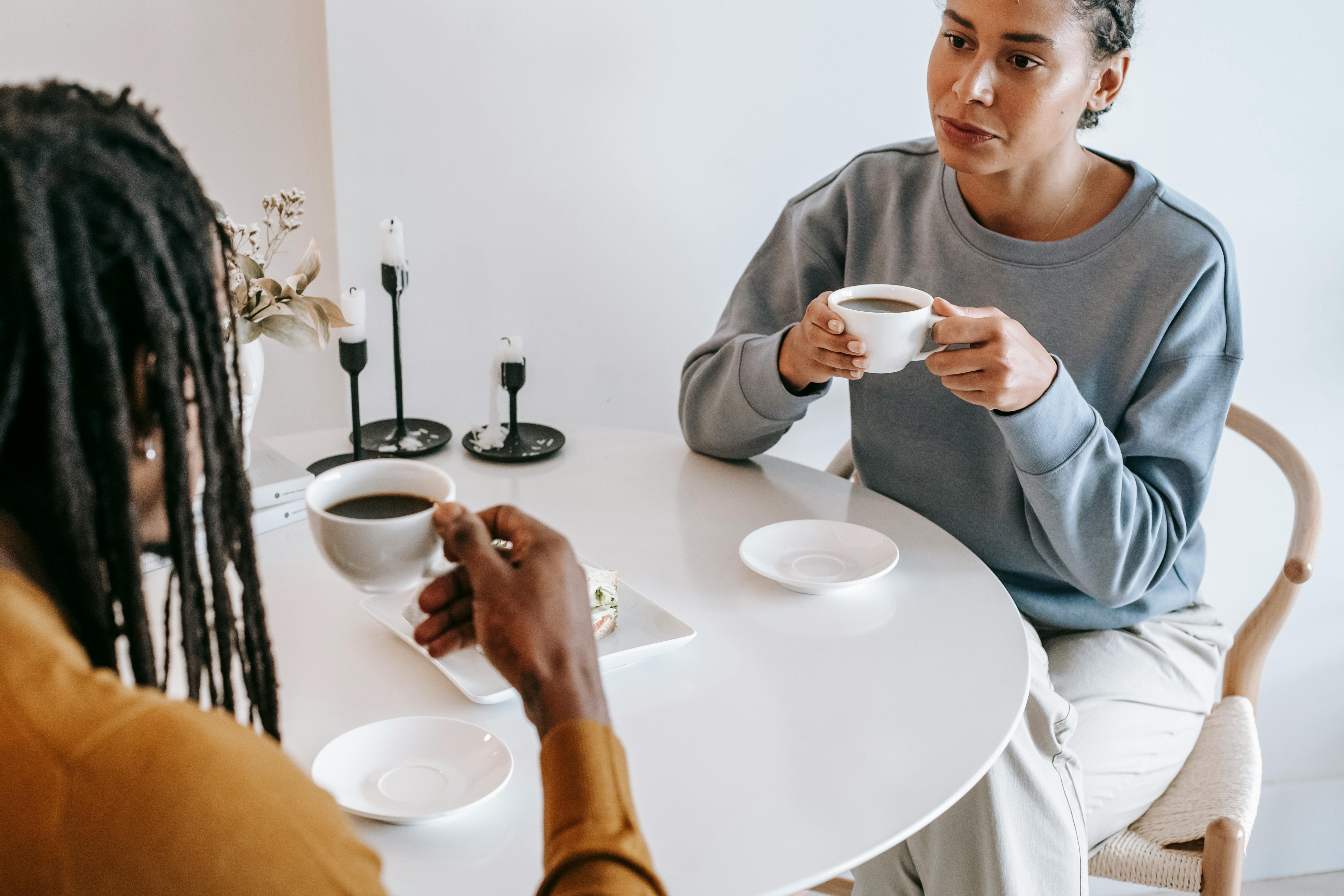 diverse couple drinking coffee together in cafe
