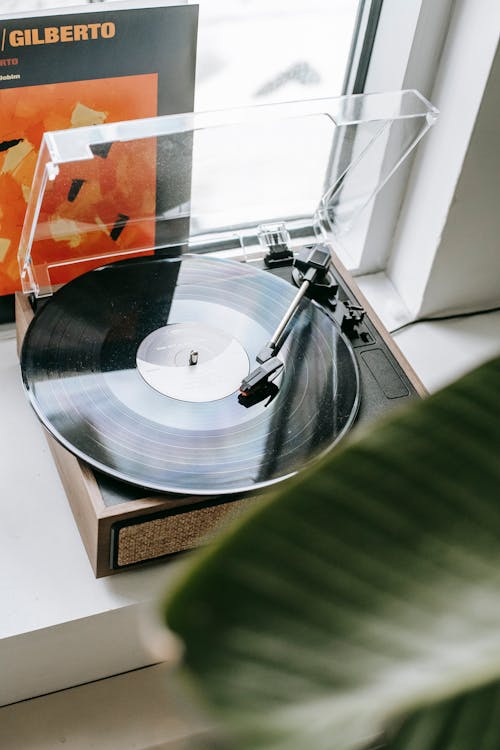 Vintage record player with disc placed on windowsill