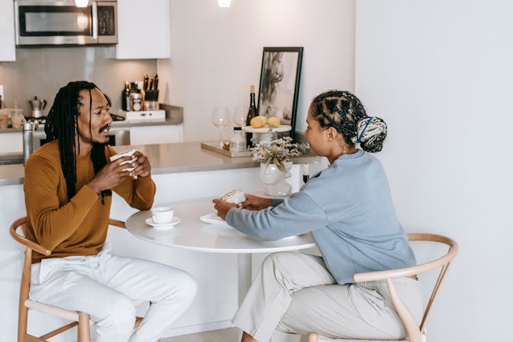 Cheerful Couple Sharing Meal At Home