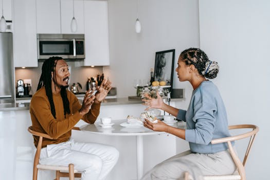 Side view of young African American male with dreadlocks in casual outfit having argument with African American 
dissatisfied female