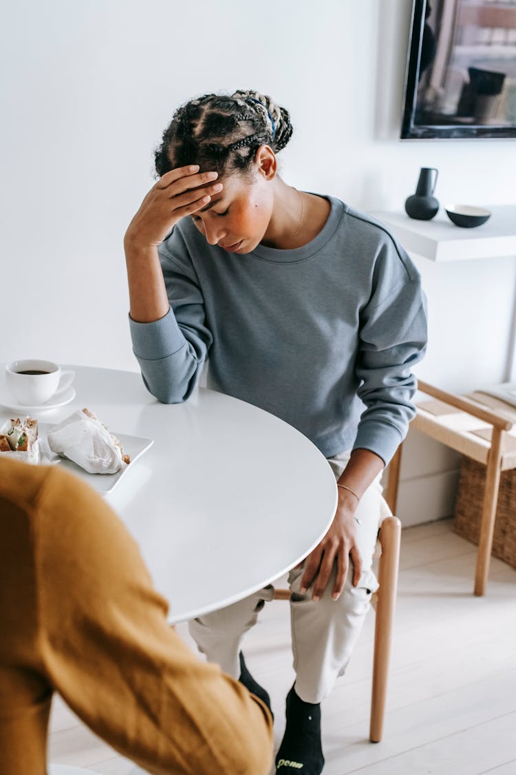 Sad Black Woman At Table With Boyfriend