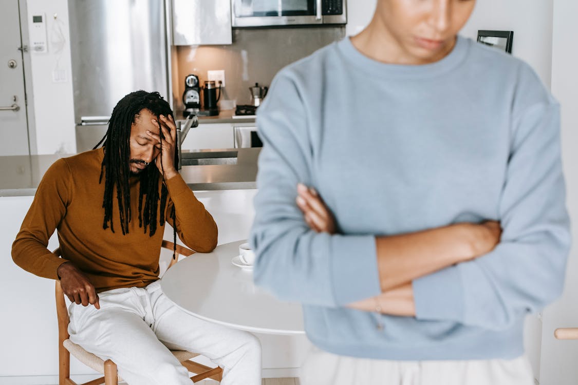 African American couple arguing with each other in kitchen