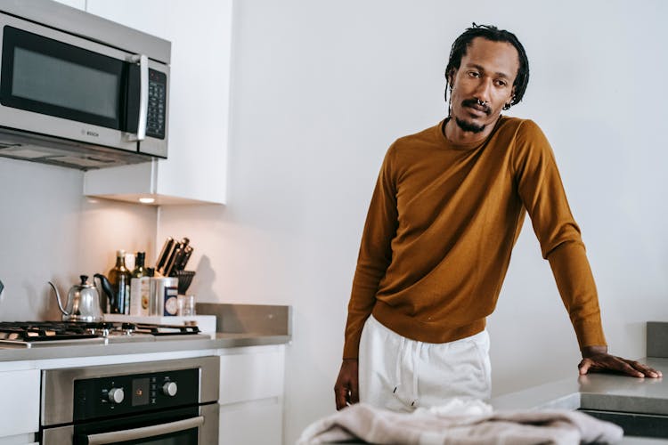 African American Guy Standing In Kitchen At Home