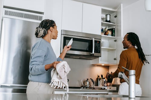 Black couple having conflict in kitchen