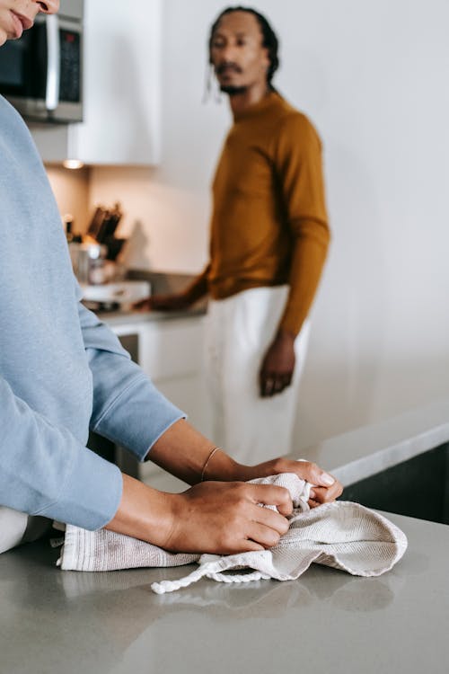 African American couple having conflict while standing in kitchen in daylight and wearing casual outfit