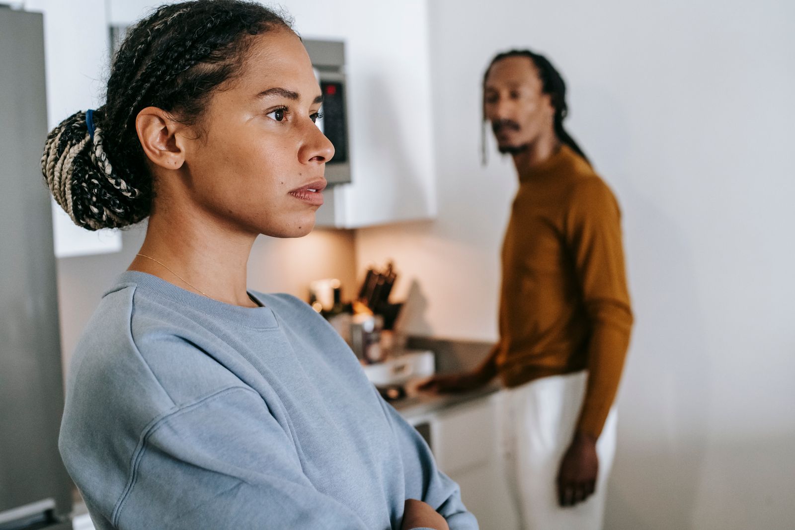 A couple facing away from each other during a tense disagreement at home