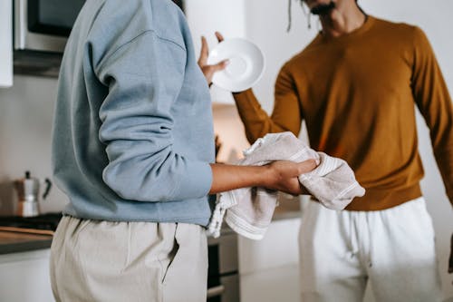 Anonymous black lady and guy arguing in kitchen